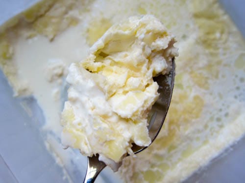 gritty clotted cream on spoon